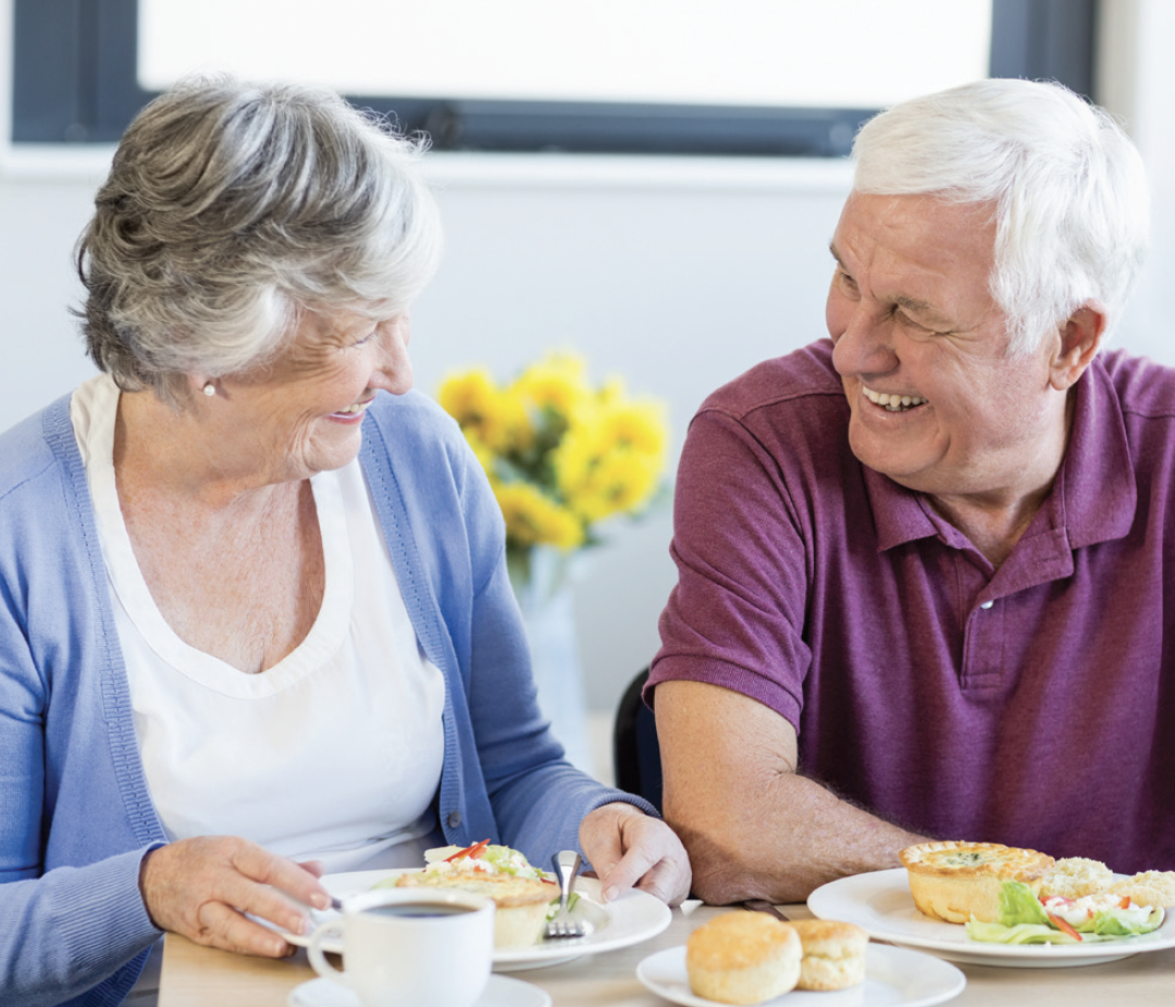 Smiling and eating breakfast together